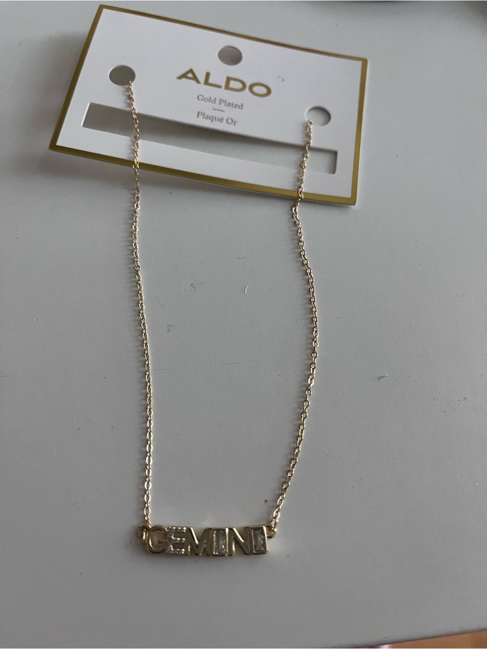 Brand new with tags ALDO Gold Gemini Letterplate Necklace with rhinestones